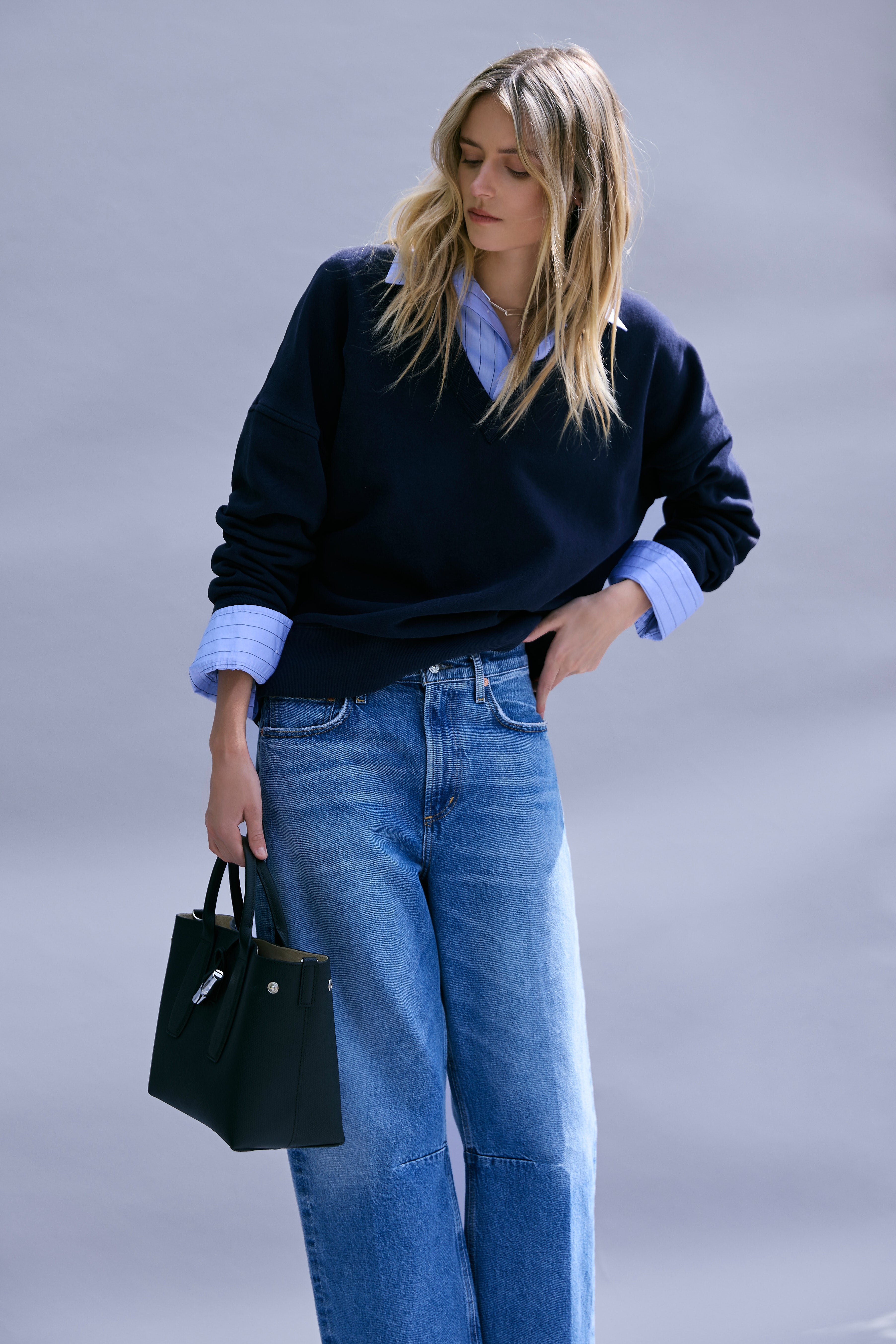 The Citizens of Humanity Ronan V-Neck Sweater, Fino Cropped Shirt in Ellis Stripe, and Miro Relaxed Jean paired with the Longchamp Roseau Handbag