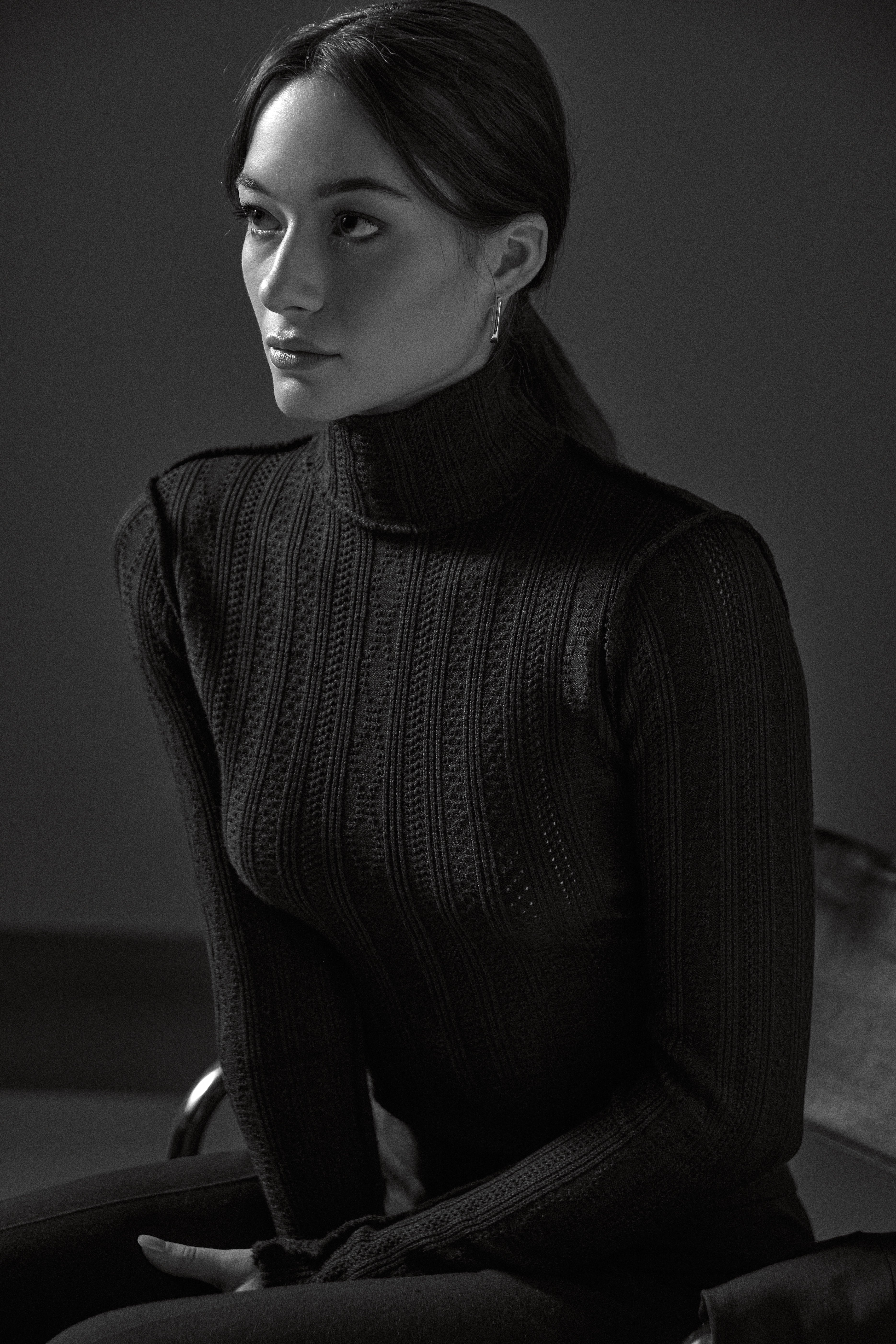 The Pointelle Knit Turtleneck, and Classic Pant by Smythe on a woman wearing Jenny Bird U Link earrings sitting on a Marcel Breuer Cantilever Chair.