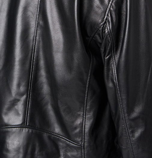 Close-up view of black cows hide leather fabric, showing its rich texture and glossy finish. 