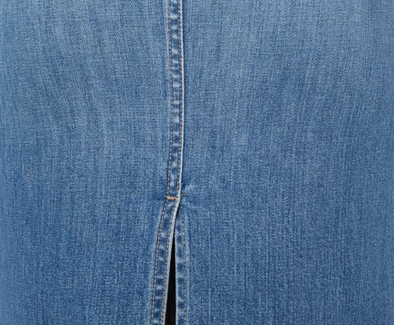 Close-up view of medium wash denim fabric, showcasing its classic blue hue and distinctive weave texture.  