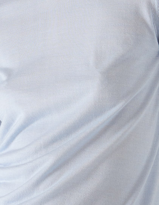 Close-up view of baby blue lyocell fabric, showcasing its smooth texture and breathable quality. 